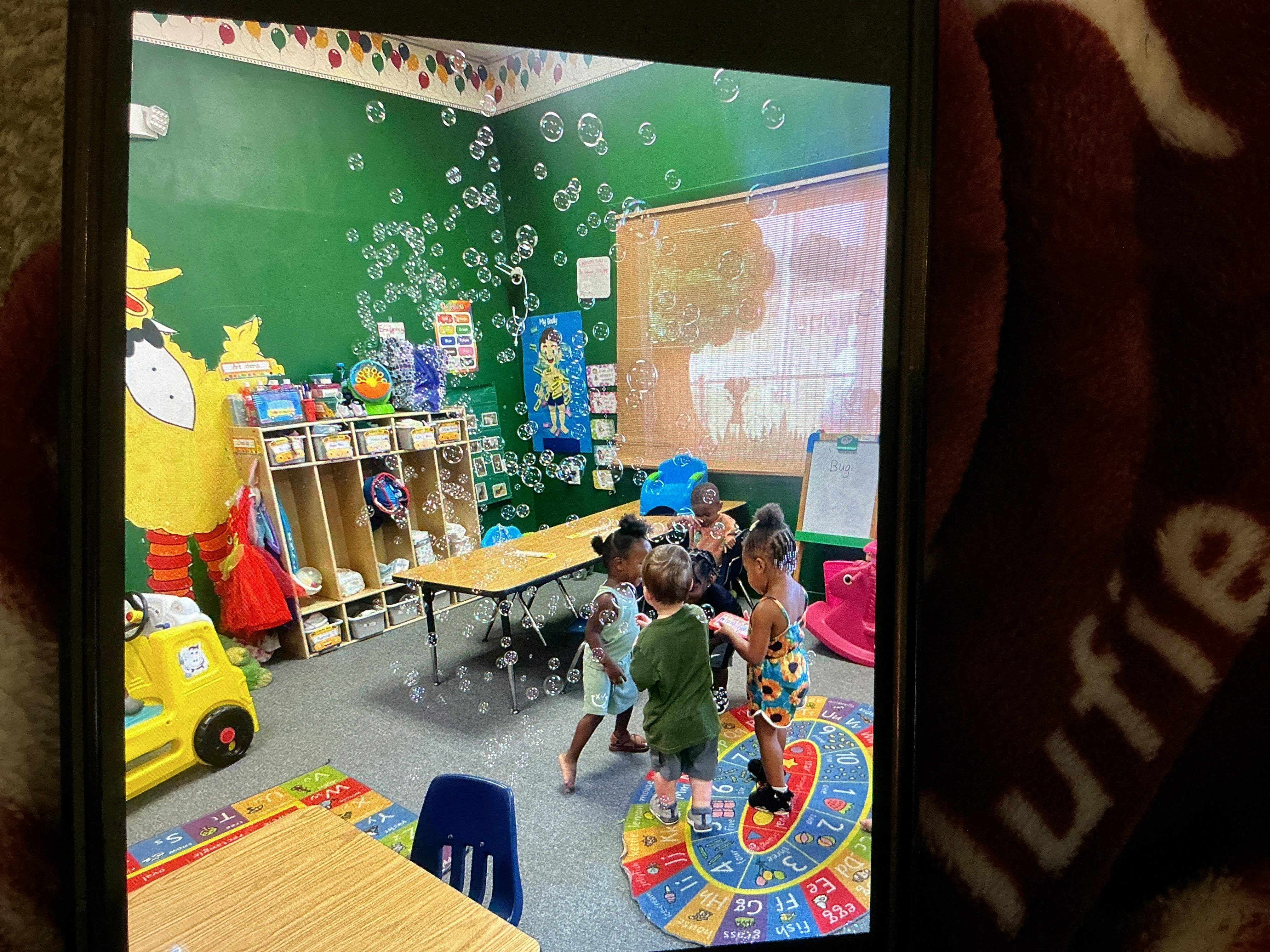 Children playing with bubbles in a classroom