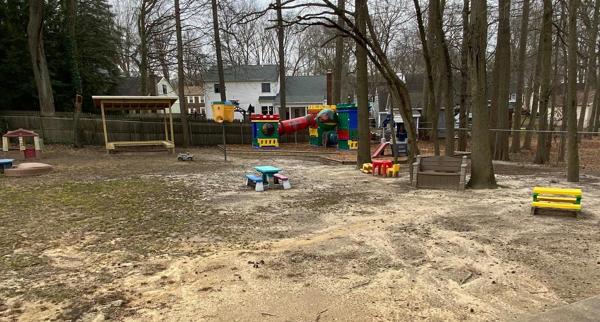 Outdoor playground with various play structures and sand
