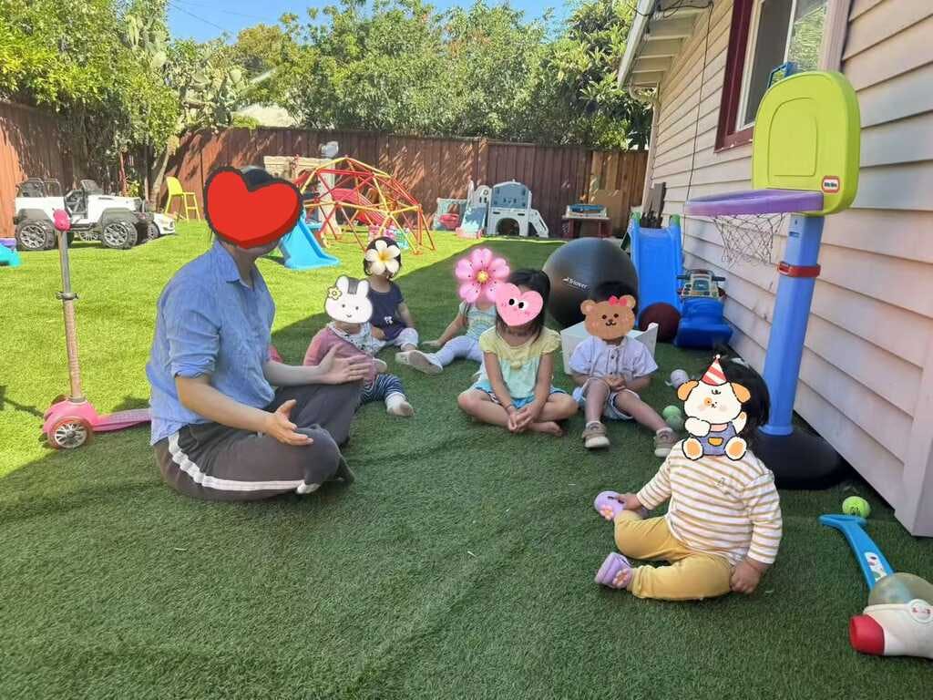 Person with several children on artificial grass in a backyard