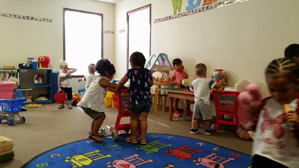 Children playing in a room with toys