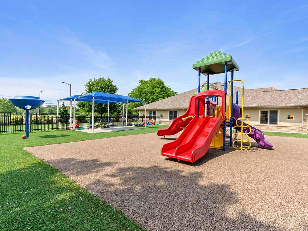 Colorful playground with slides, play structure, and covered area