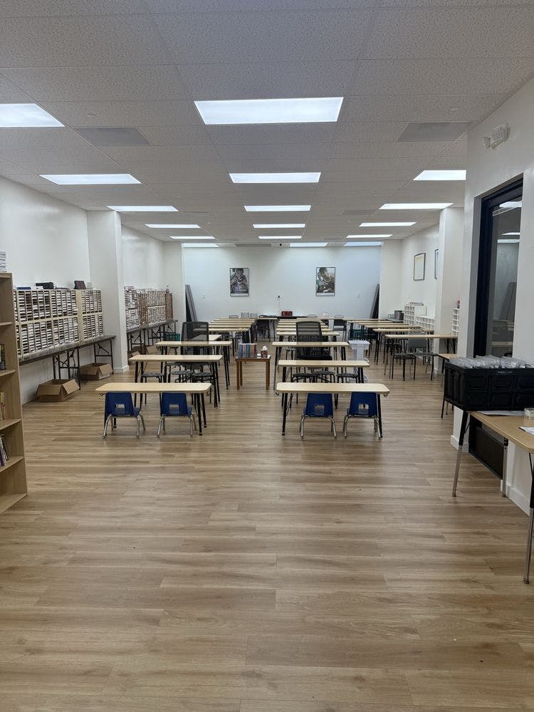 Empty classroom with multiple desks and chairs