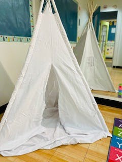 Two white teepees in a room