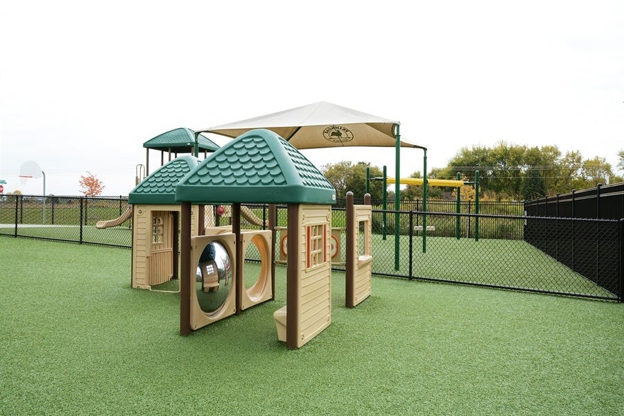 Playground structure with green roofs on artificial turf