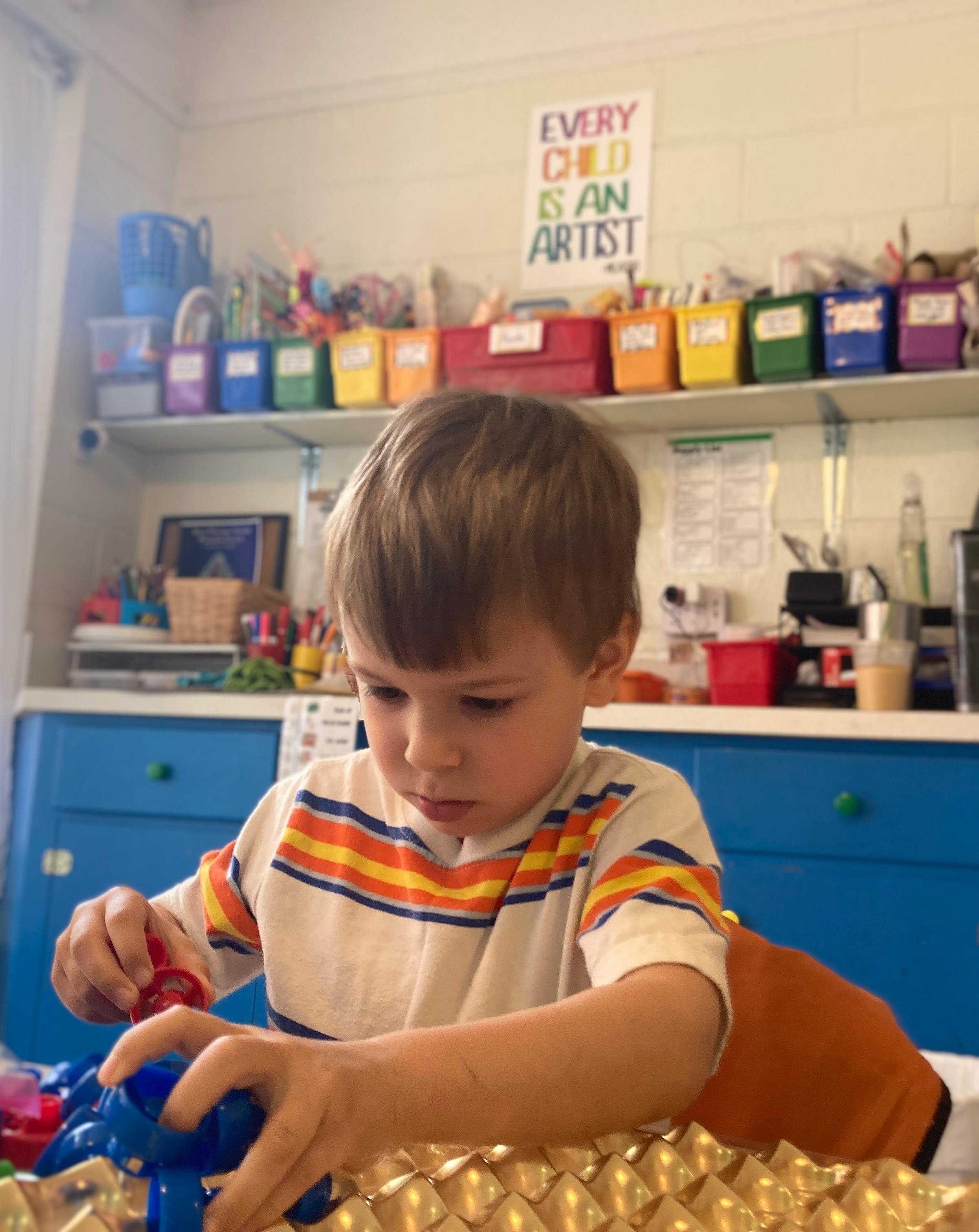 Child playing with blue and red objects