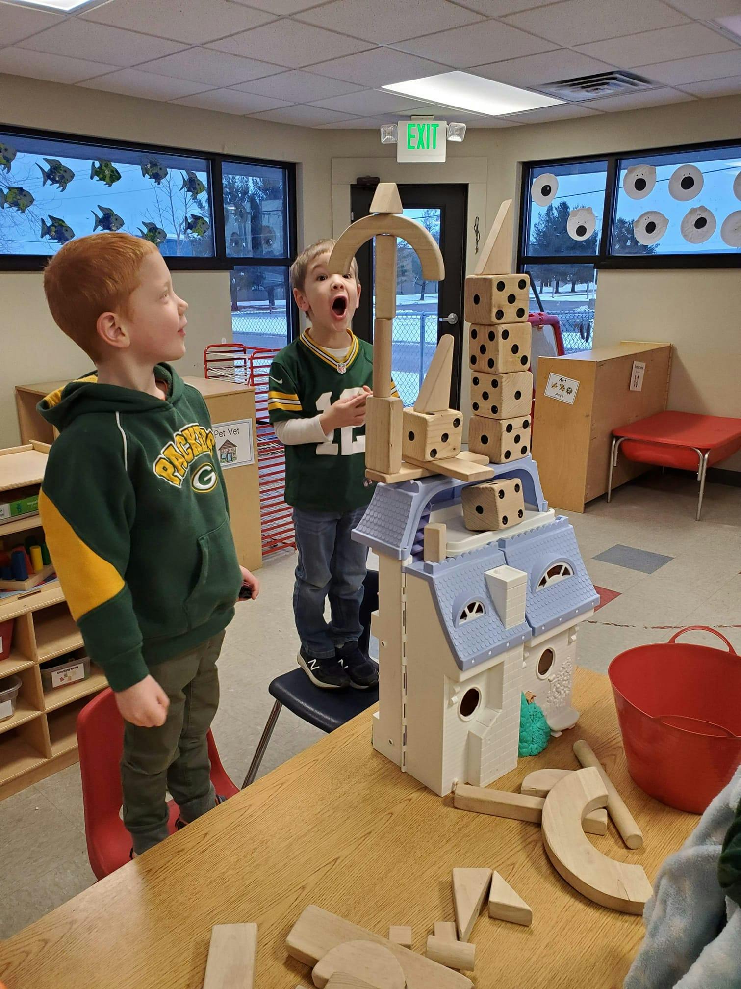 Two children playing with blocks in a classroom