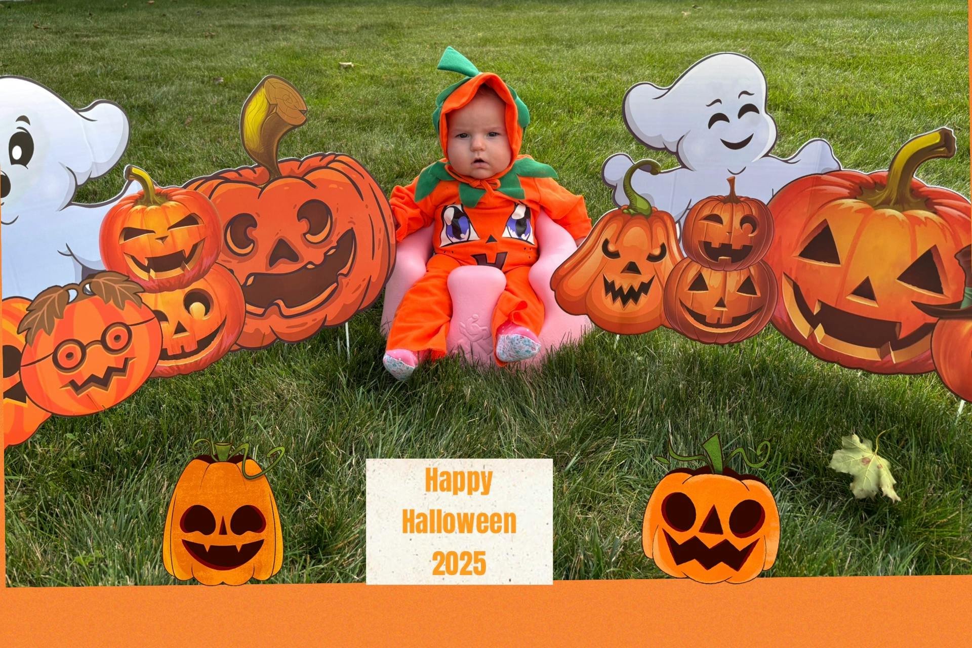 Child in pumpkin costume surrounded by Halloween decorations