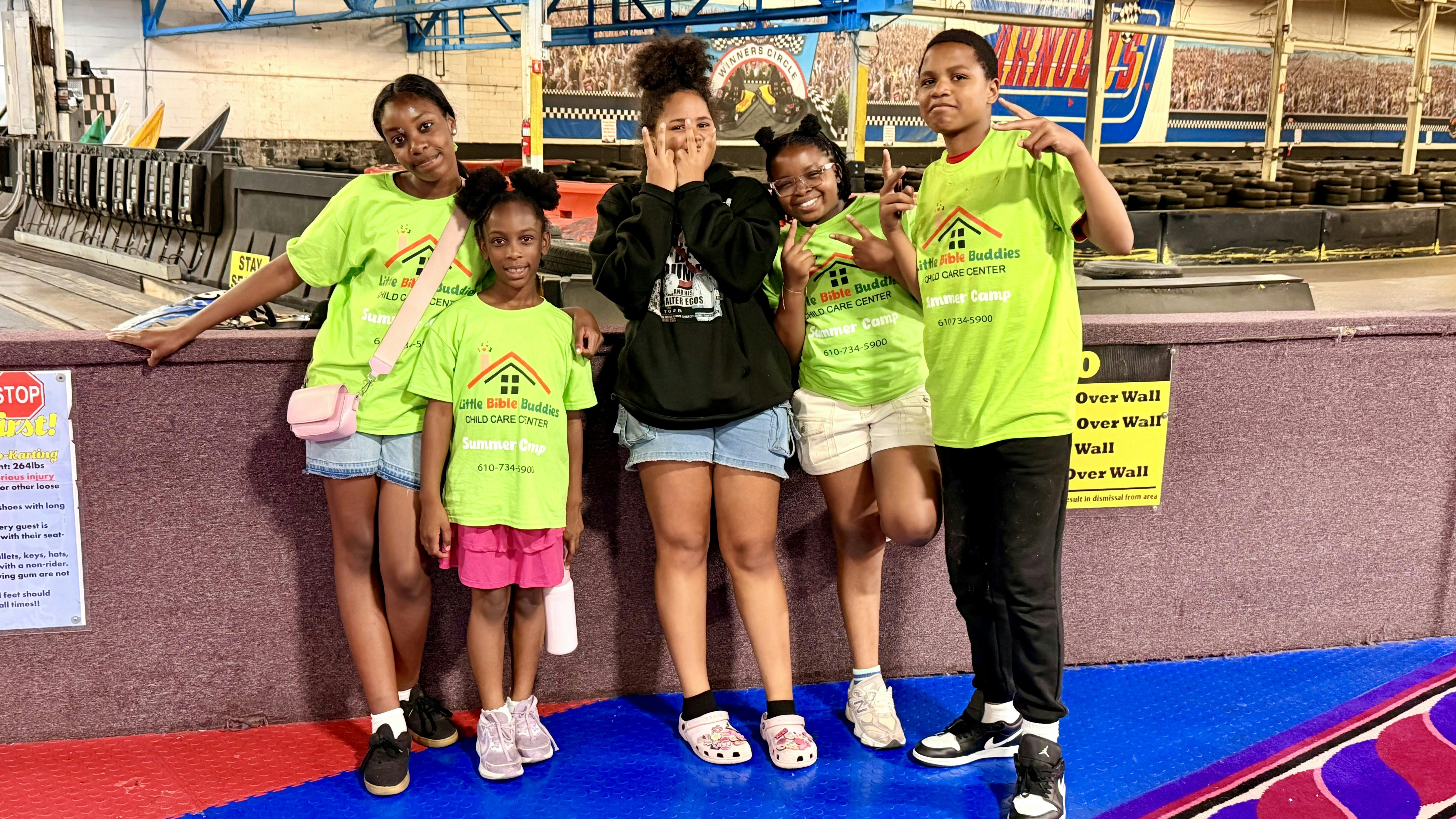 Group of children standing at a go-kart track