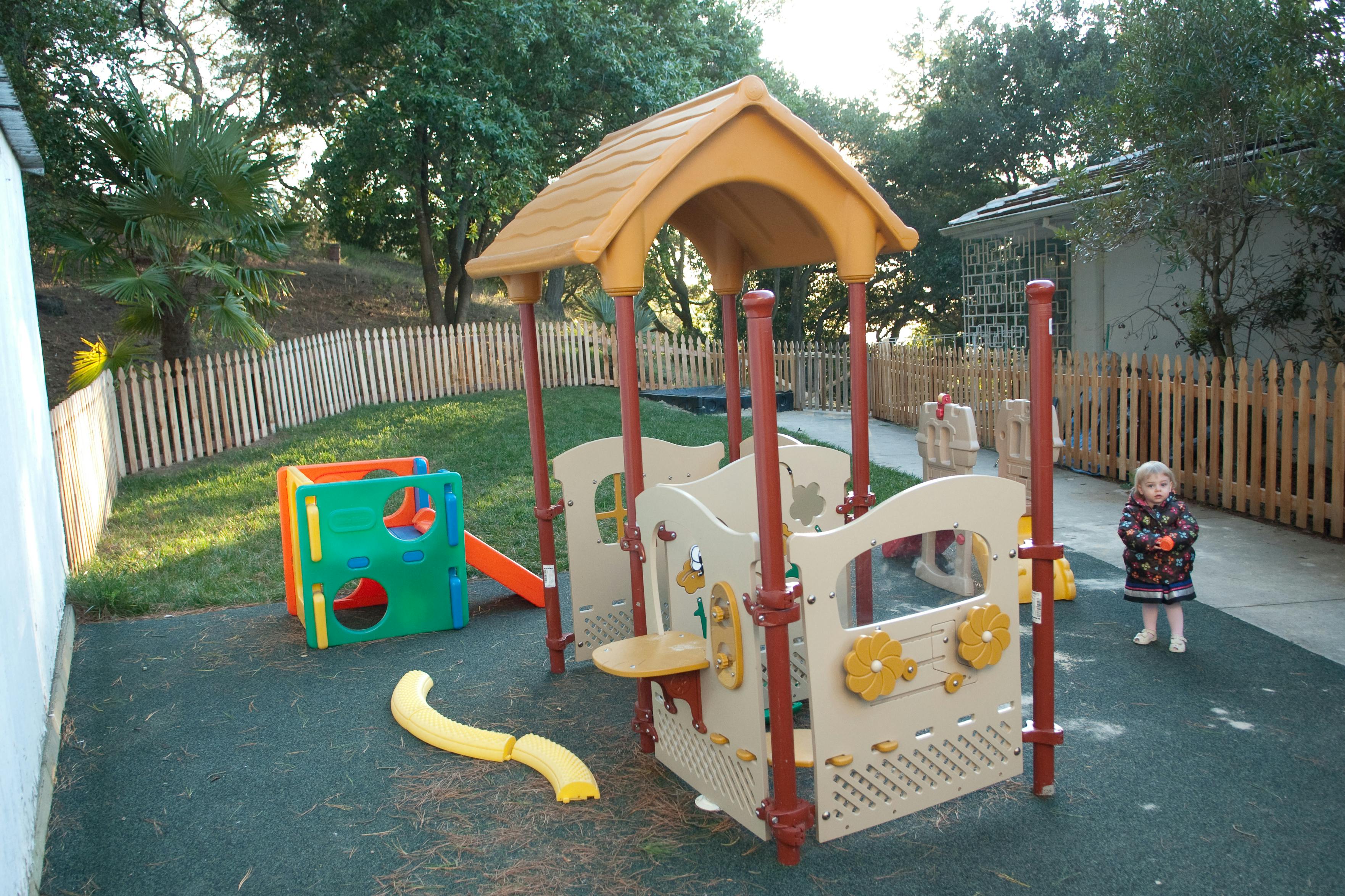 Child standing near a playground structure