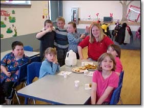 Adult and children gathered around a table