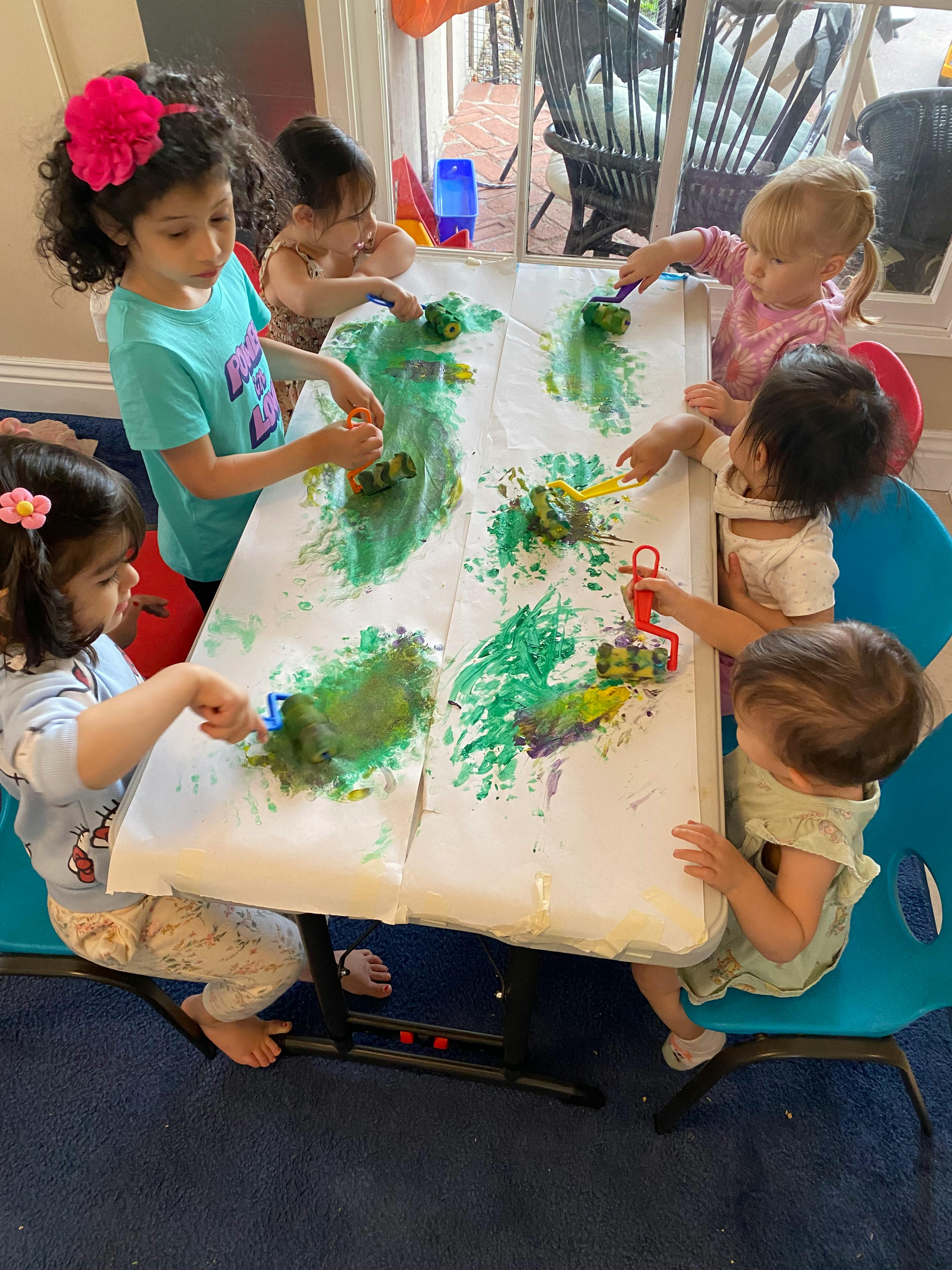 Children painting at a table