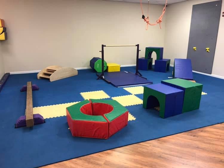 Indoor play area with various soft play equipment and a pull-up bar