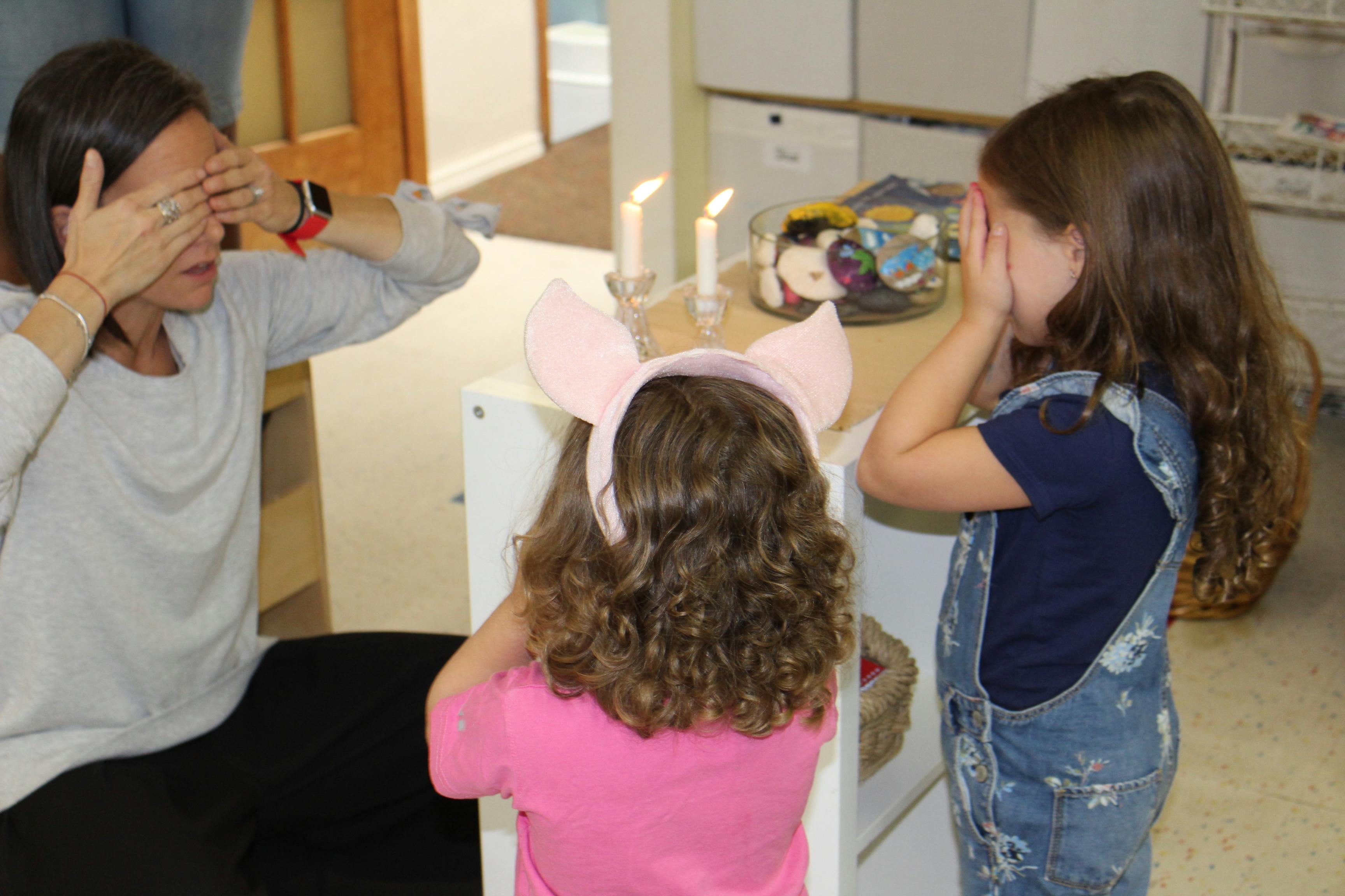 Person and two children covering their eyes