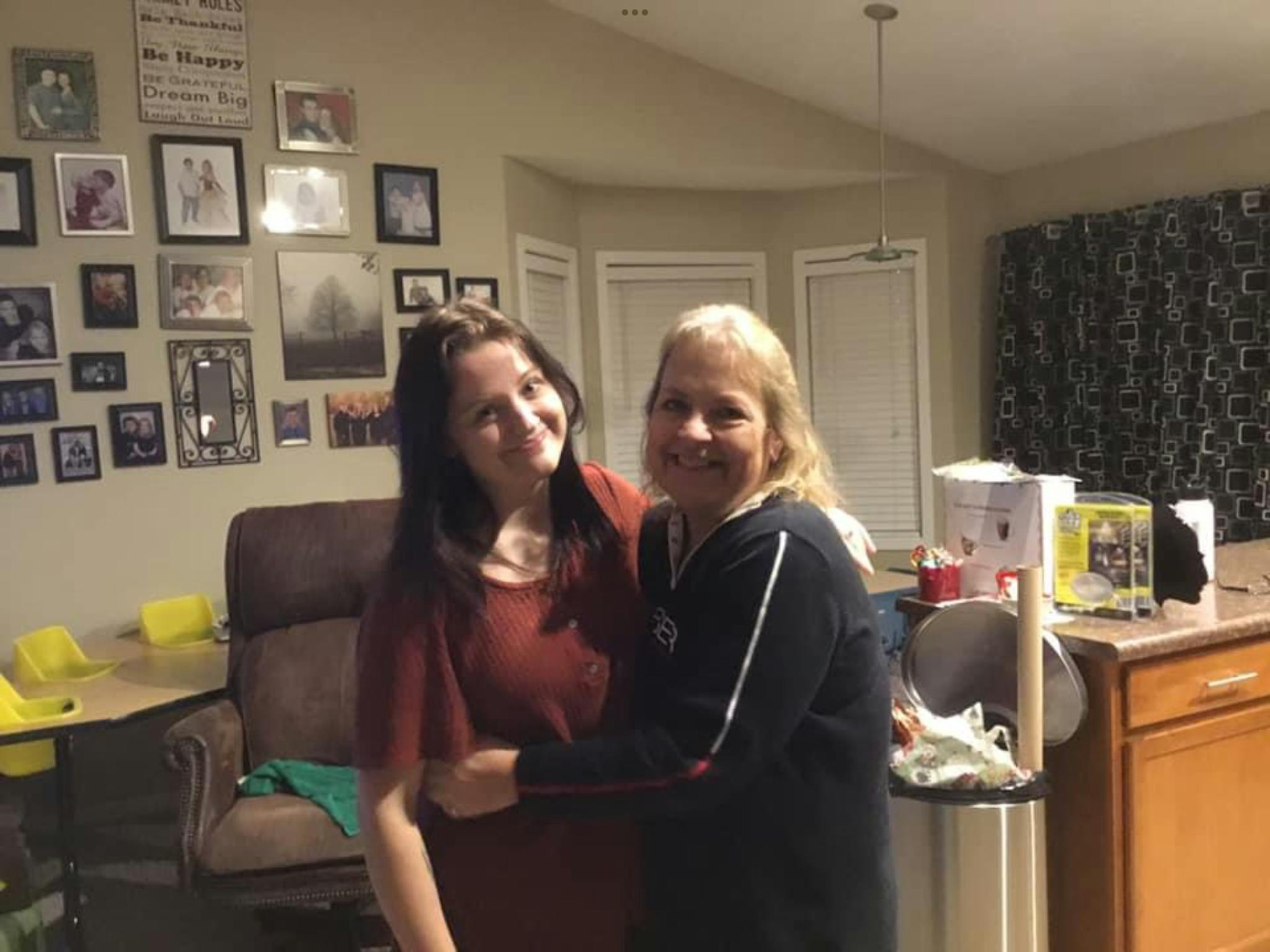 Two people standing together indoors