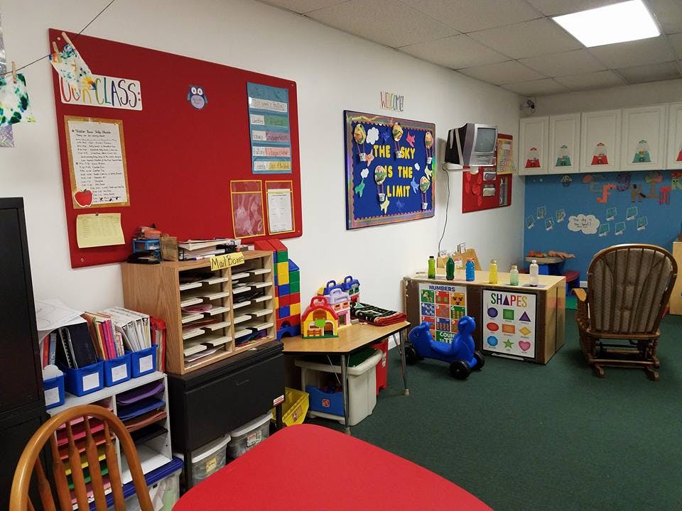 Classroom with bulletin boards, tables, and chairs