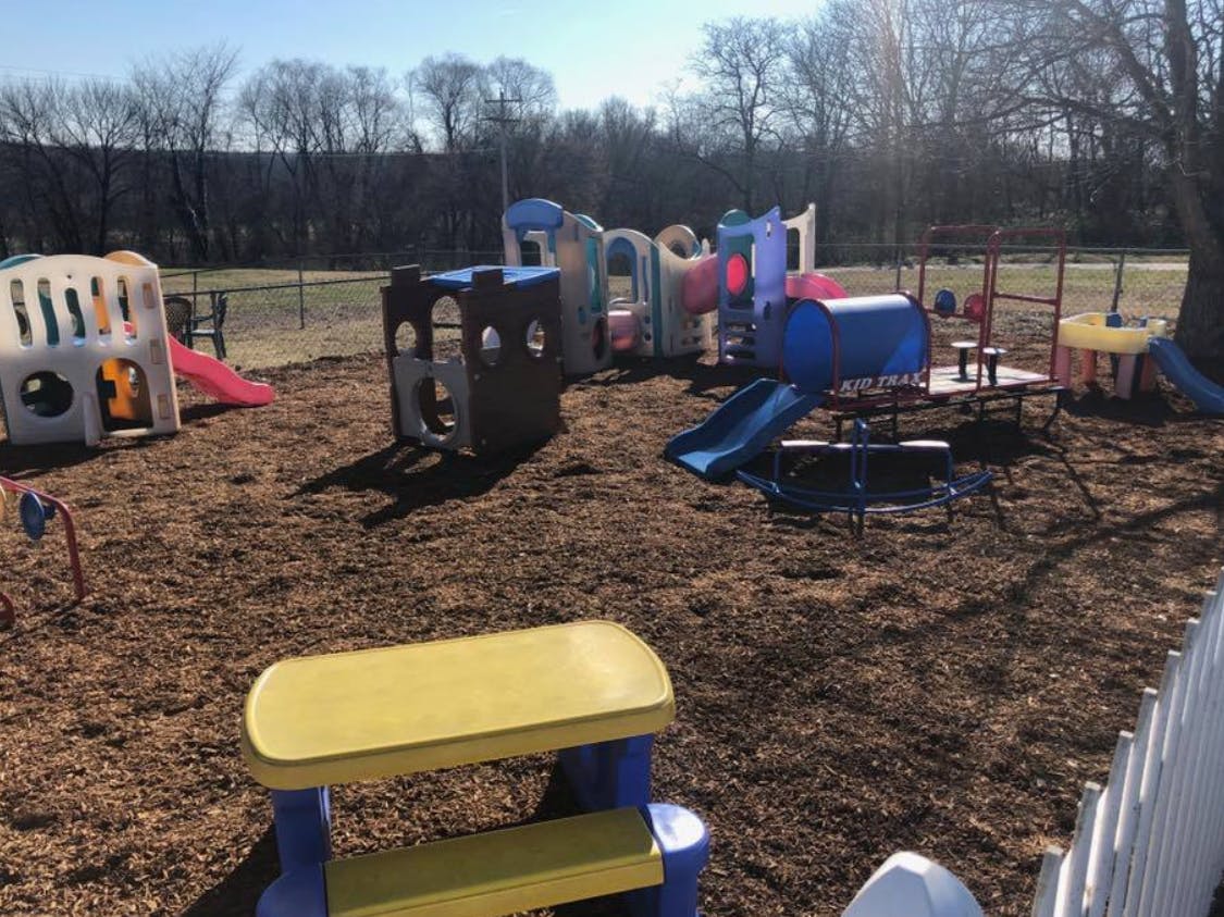 Outdoor playground with various colorful play structures and slides