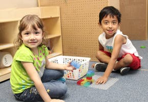 Two children playing with toys on the floor