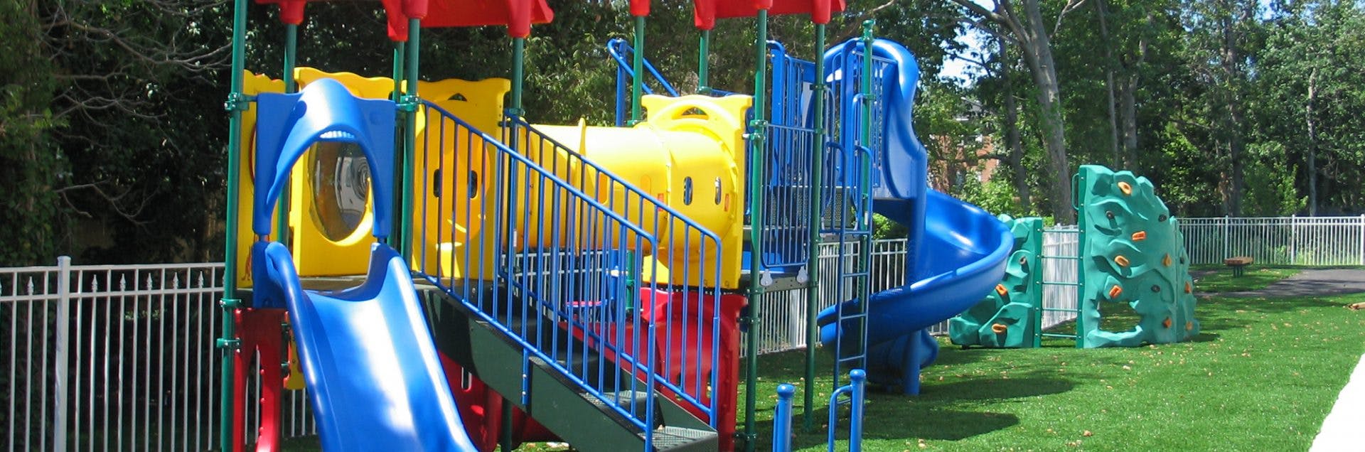 Colorful playground structure with slides and climbing walls