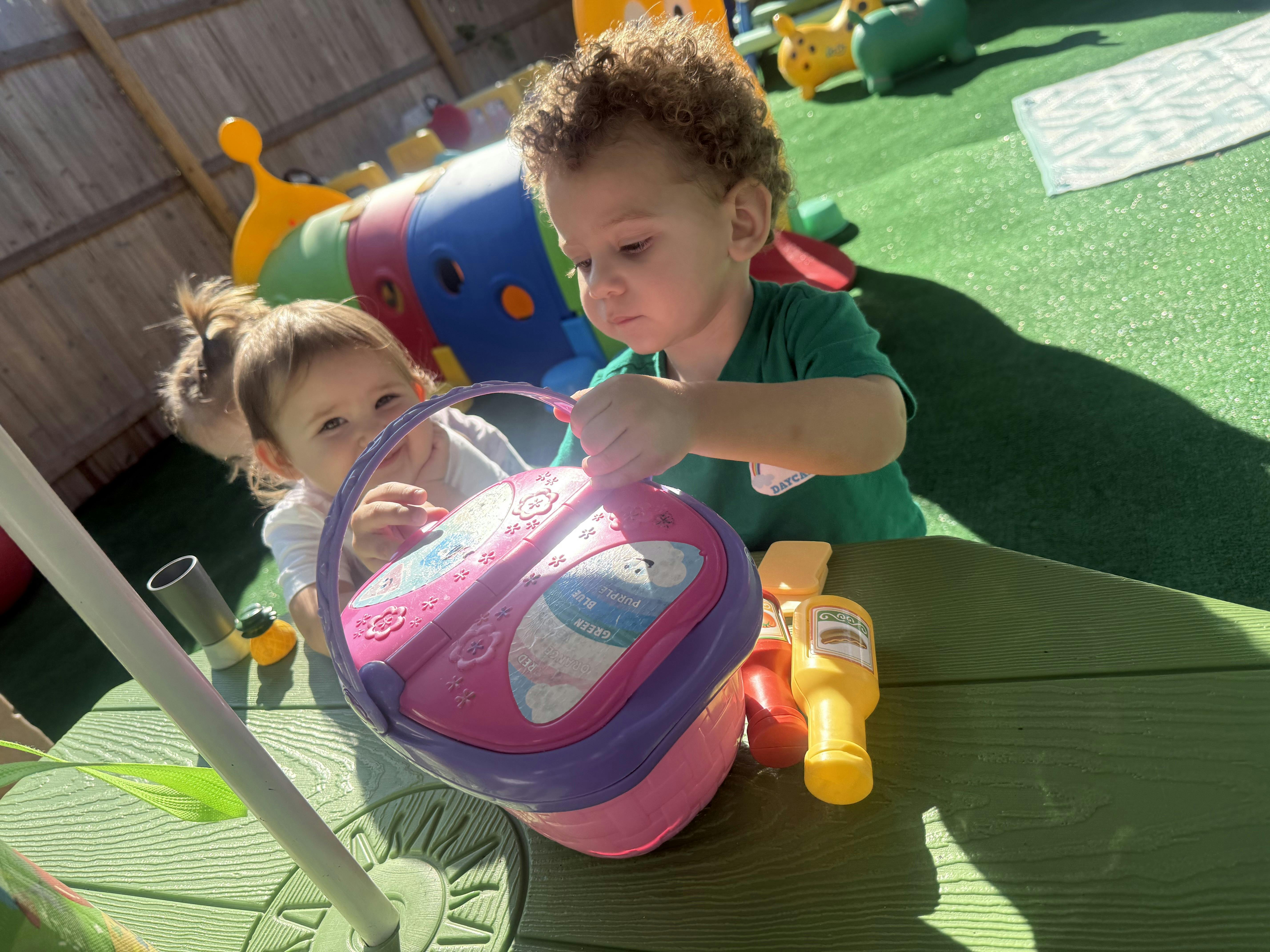Two children playing with a toy basket