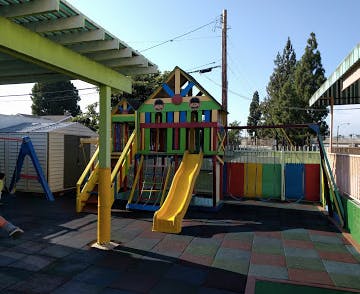 Playground with a colorful play structure, slide, and swings