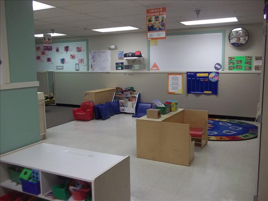 Children's classroom with small furniture, books, and educational displays