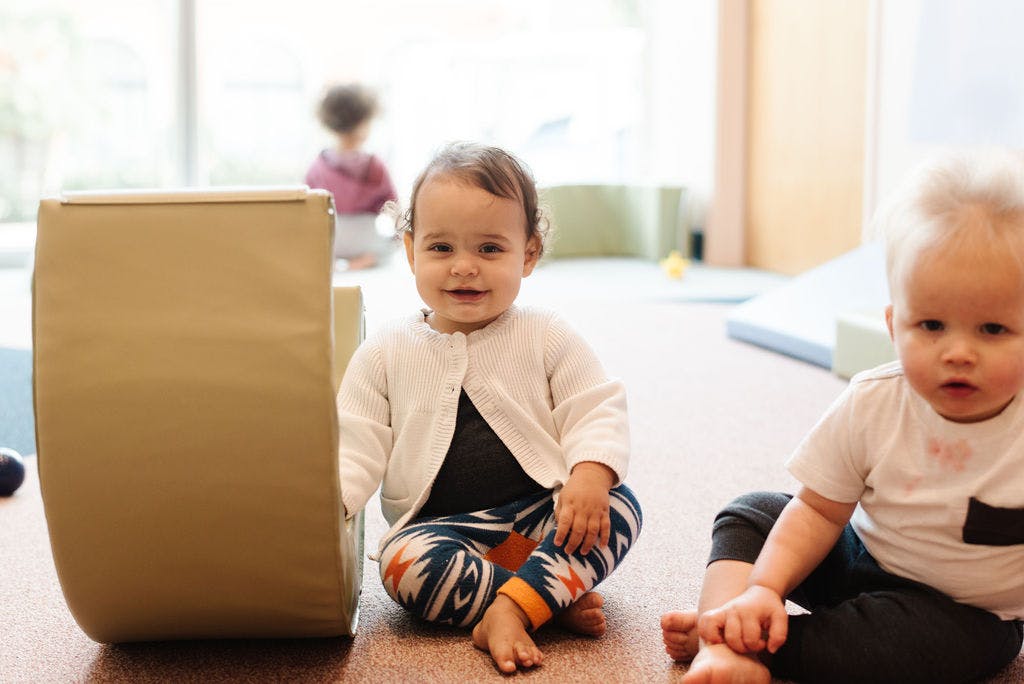 Two children sitting on the floor