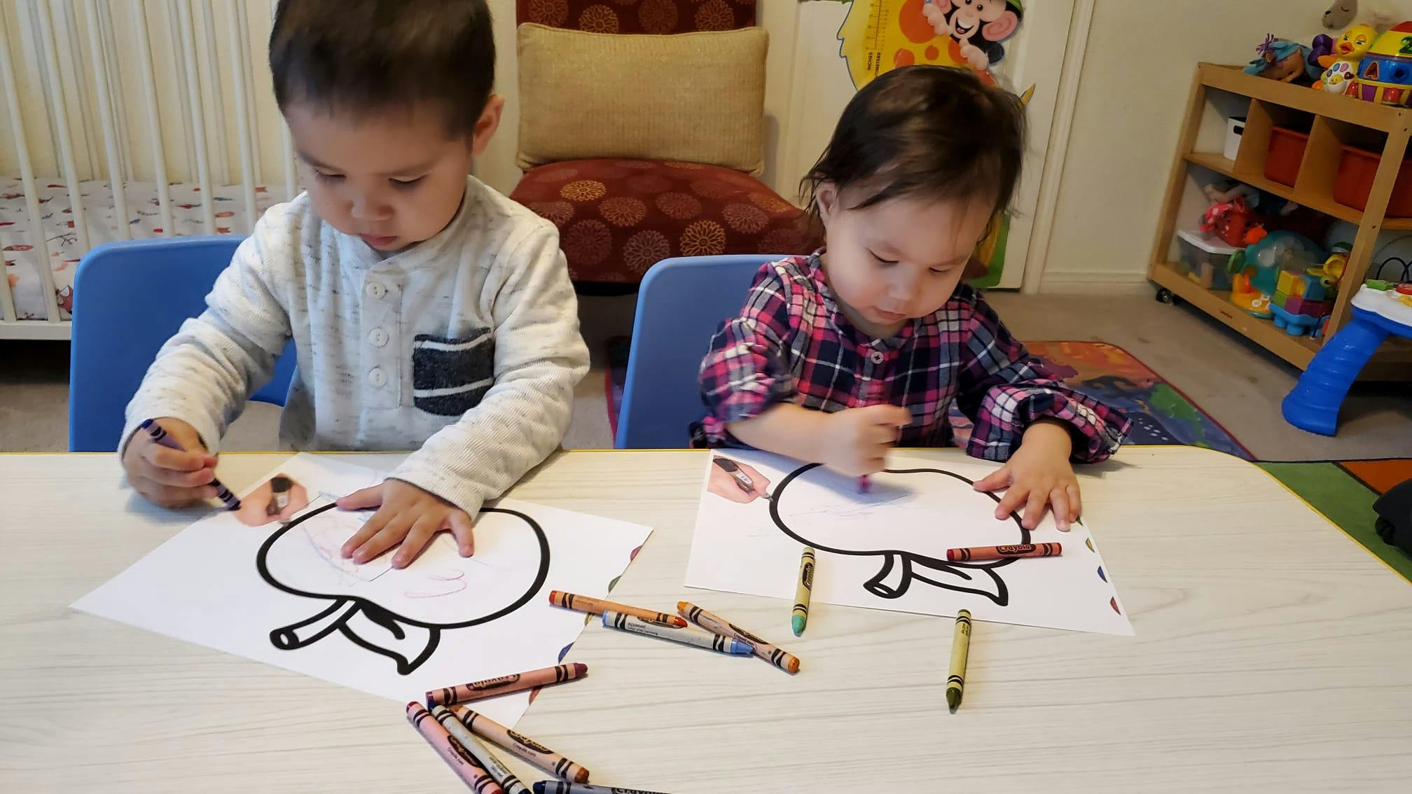 Two children coloring at a table
