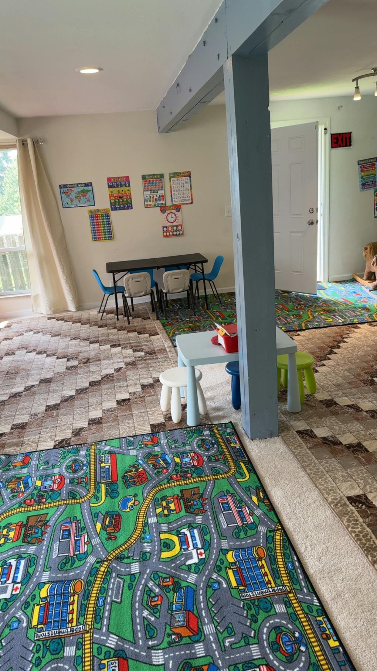 Playroom with a road map rug, small tables, and chairs