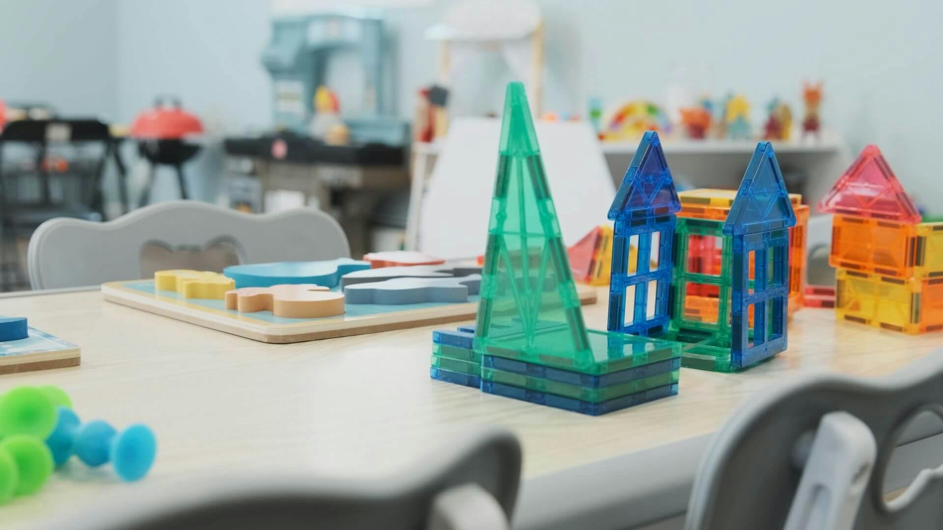 Colorful magnetic building tiles arranged on a classroom table