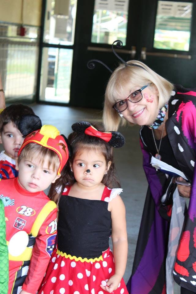 Adult and two children in costumes
