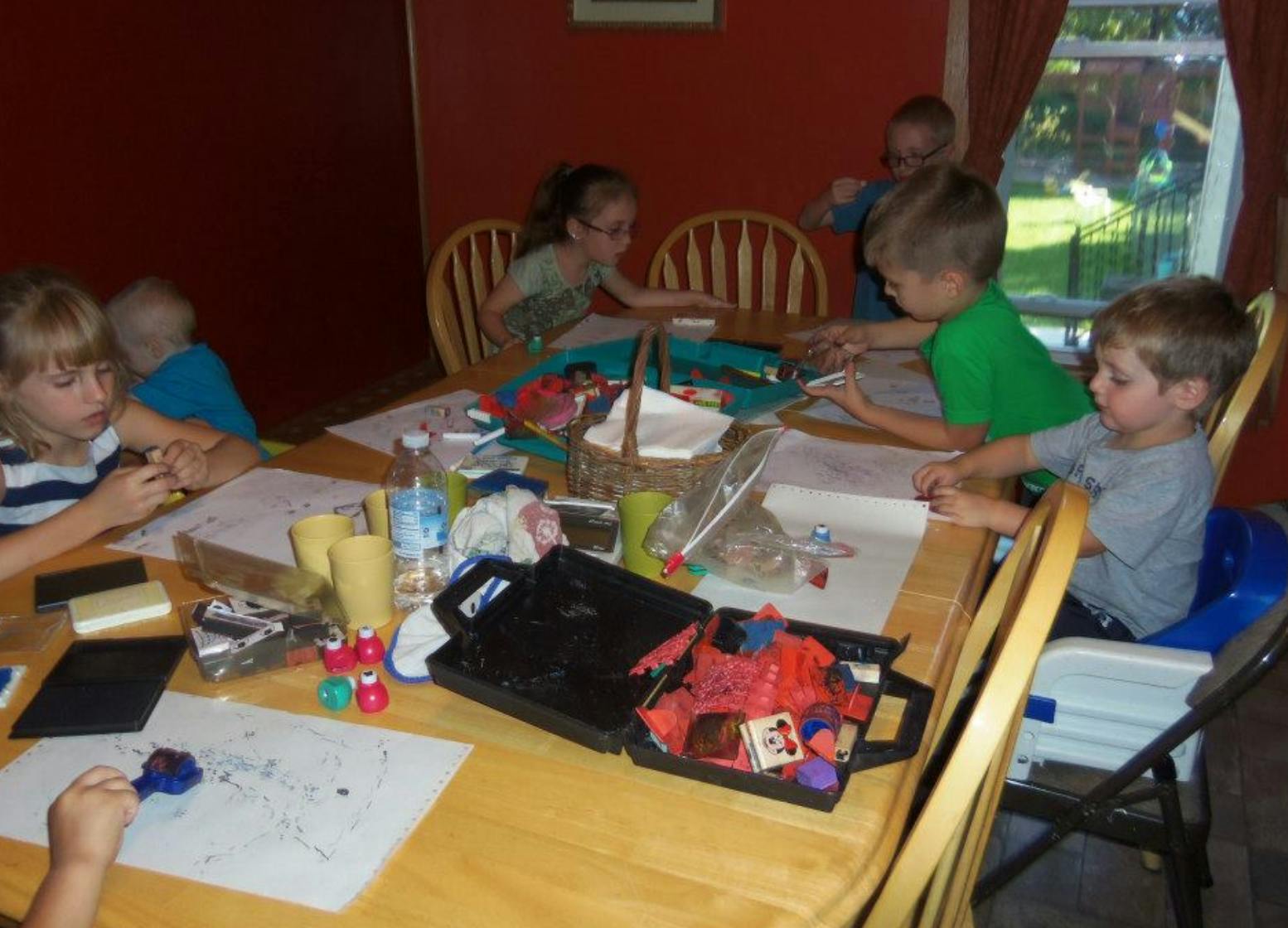 Children sitting around a table doing crafts