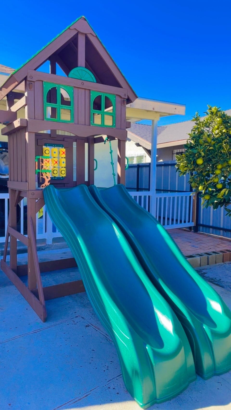 Play structure with two green slides