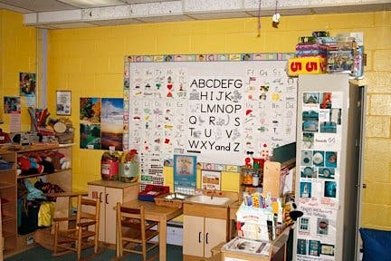 Classroom with alphabet chart on yellow wall