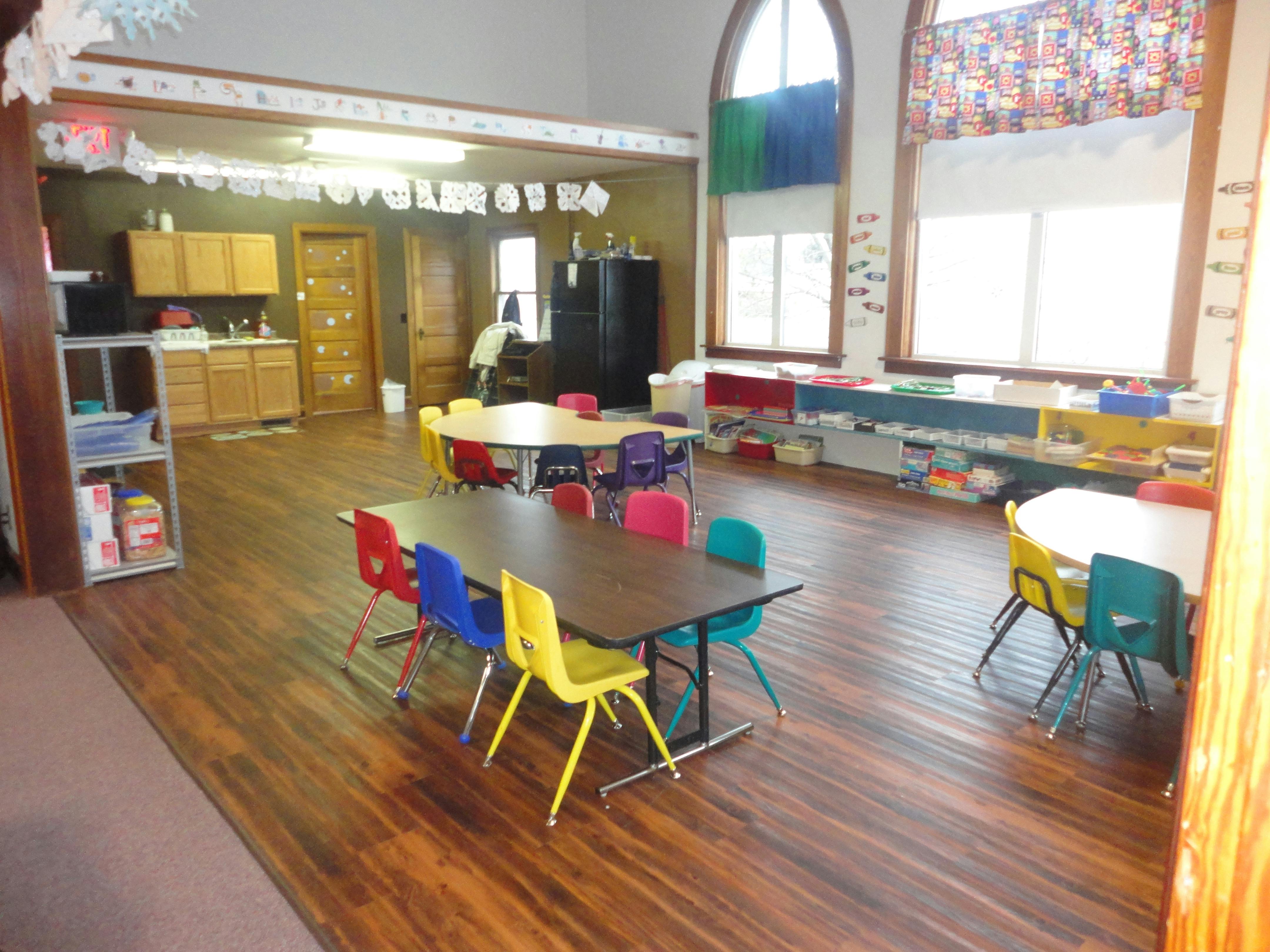 Classroom with small tables and colorful chairs