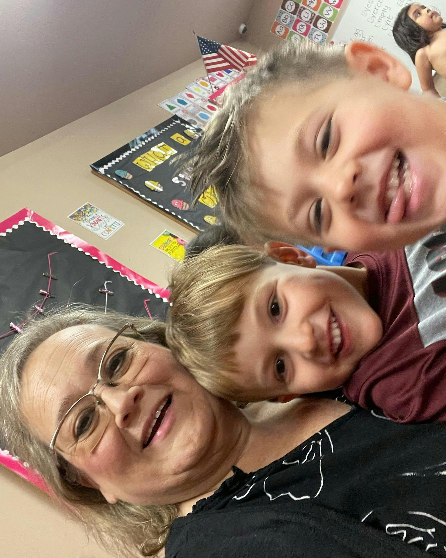 Adult and two children smiling