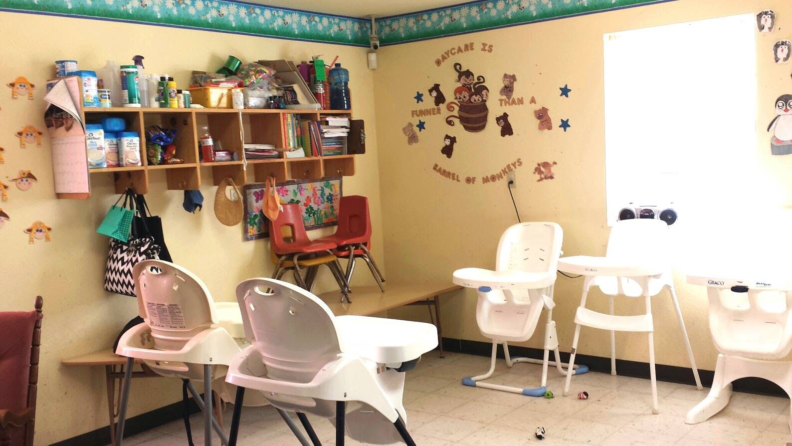 Childcare room with high chairs and shelves