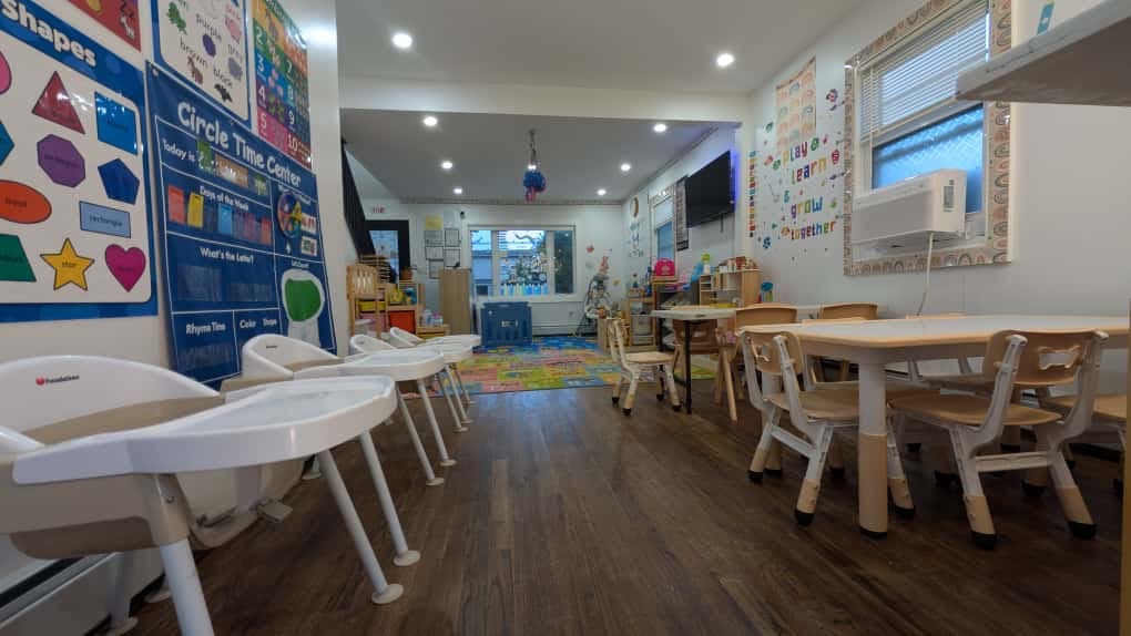 Daycare room with high chairs and small tables with chairs