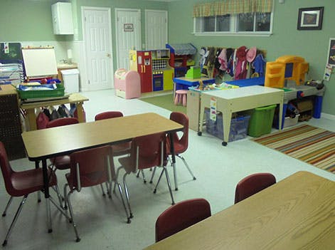 Classroom with tables, chairs, and play areas