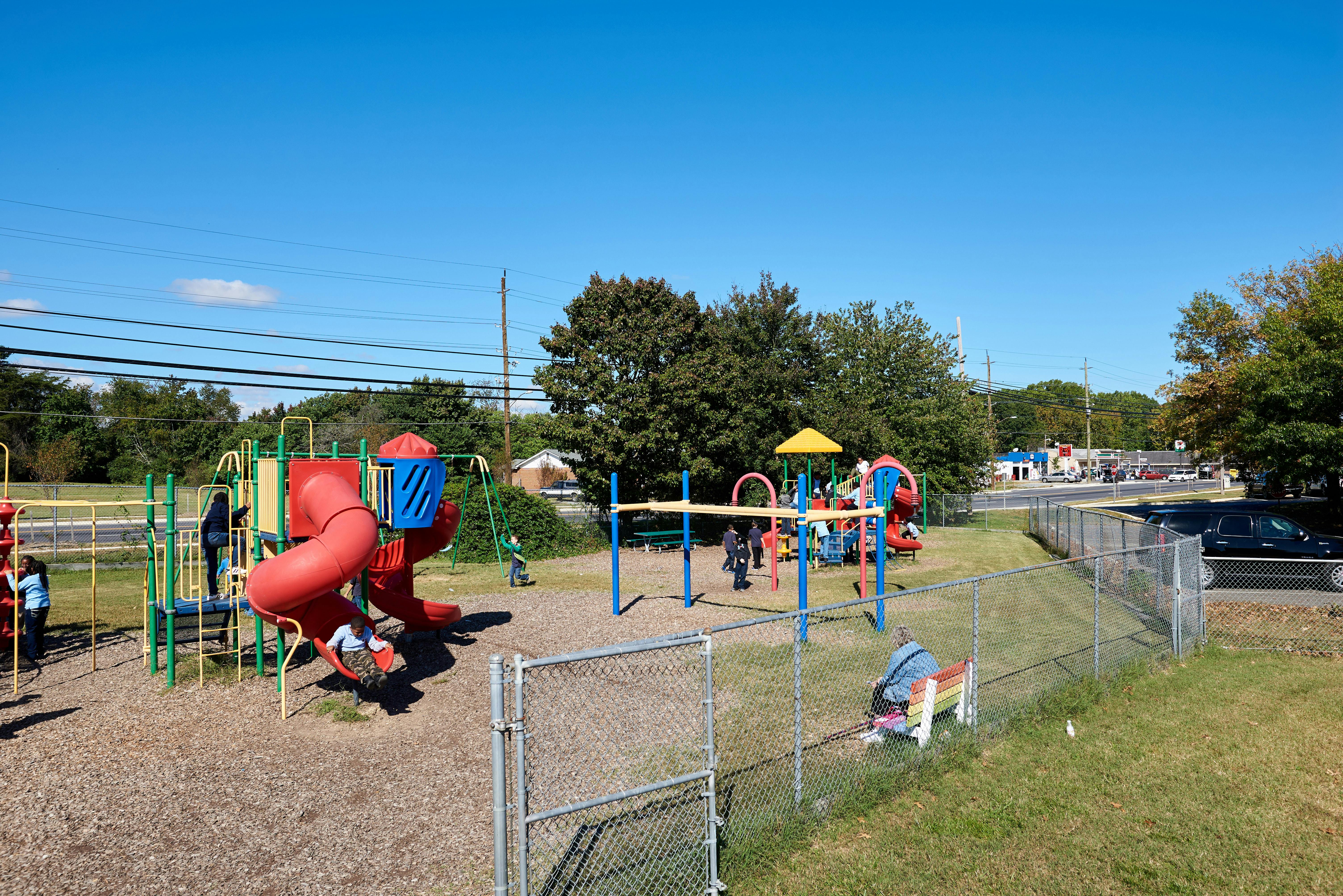 Children playing on a playground with slides and climbing structures