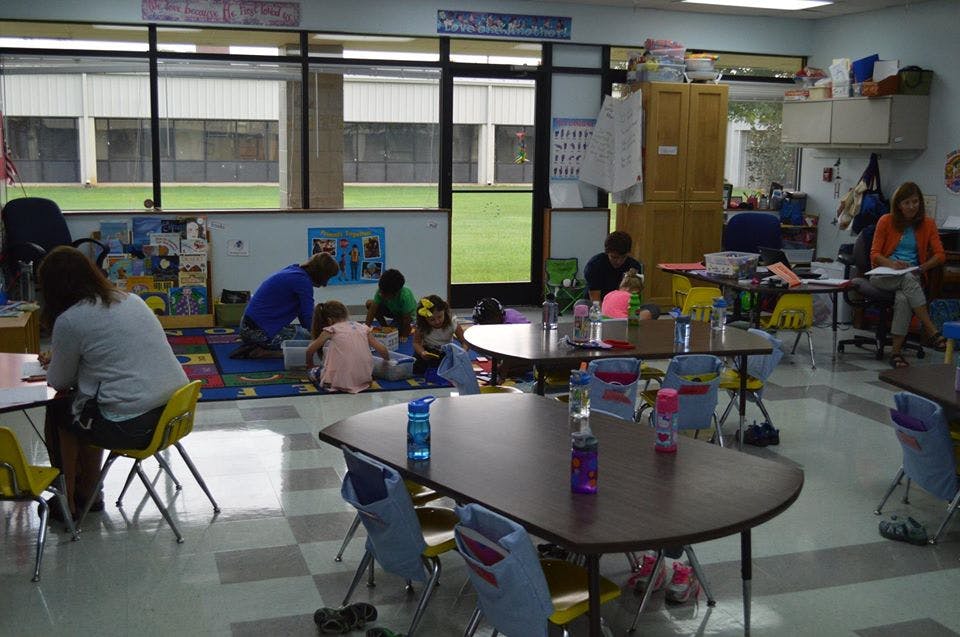 People and children in a classroom