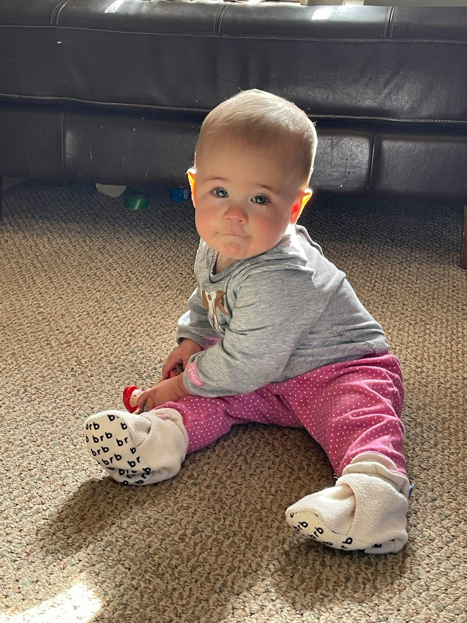 Child sitting on a carpeted floor