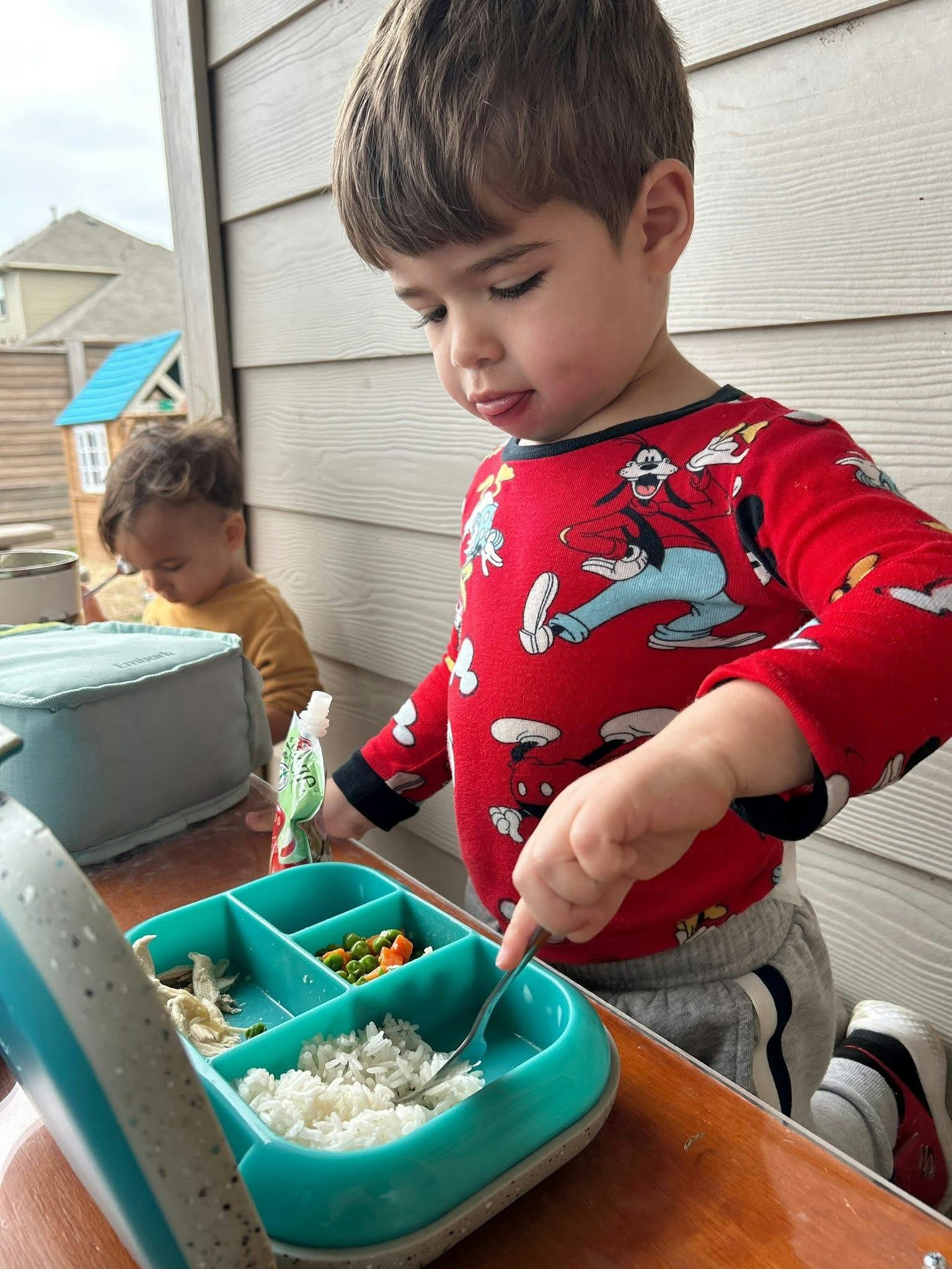 Child eating from a divided plate with a fork