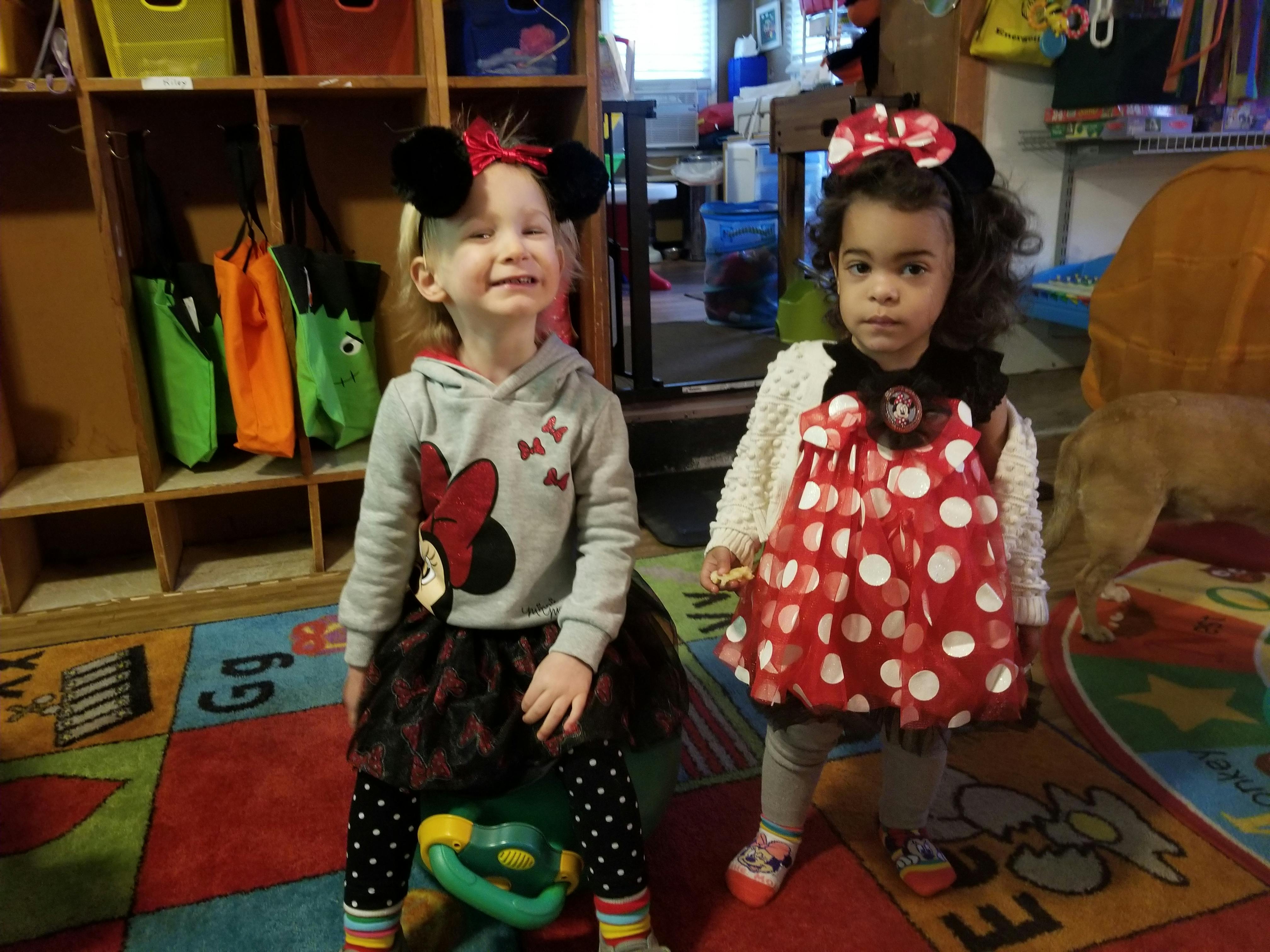 Two children in Minnie Mouse themed outfits