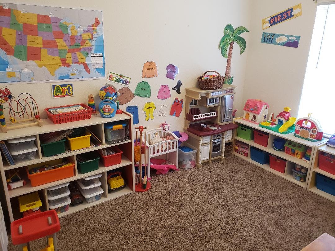 Playroom with shelves of toys and a play kitchen