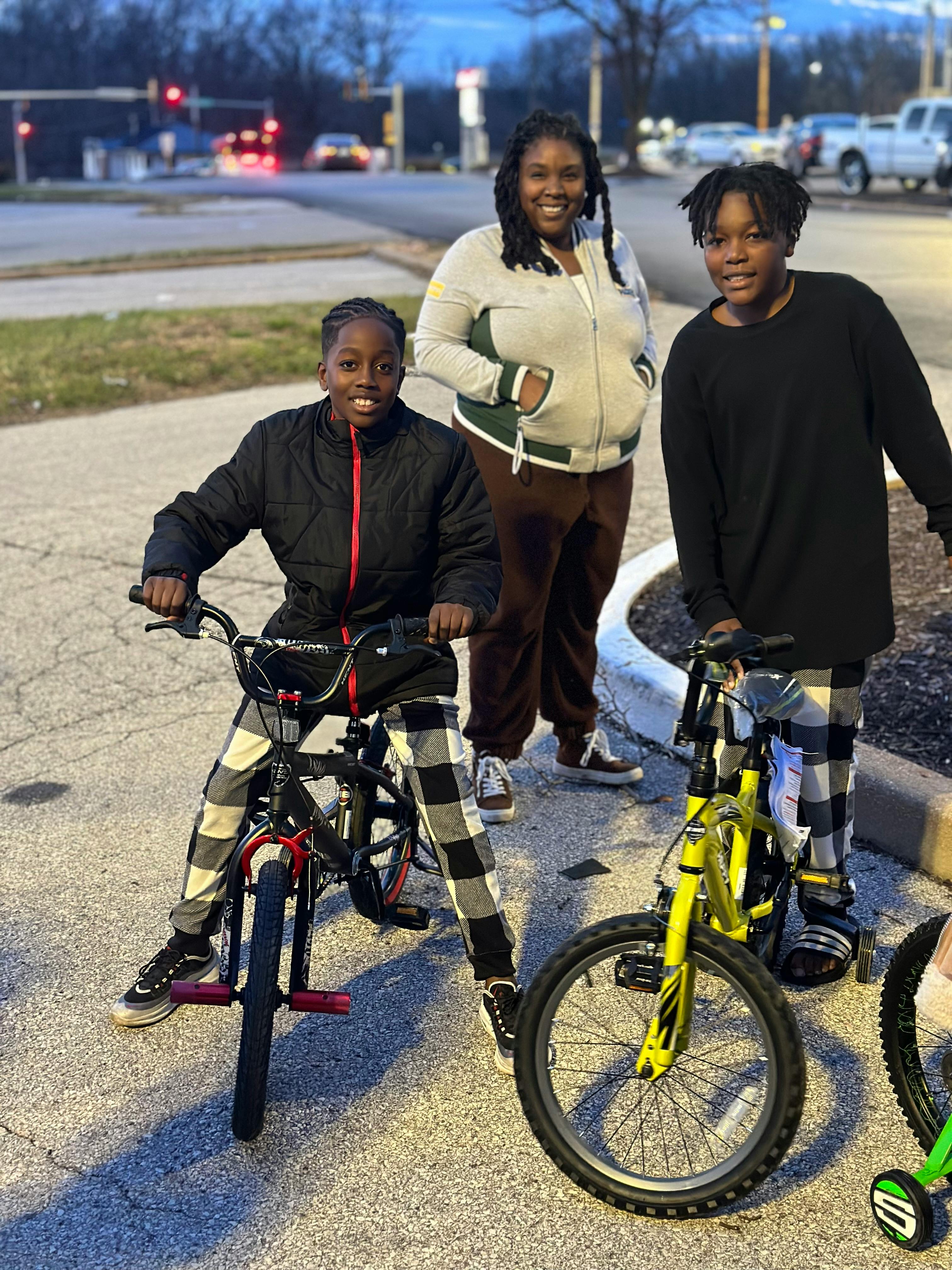 Person and two children with bicycles