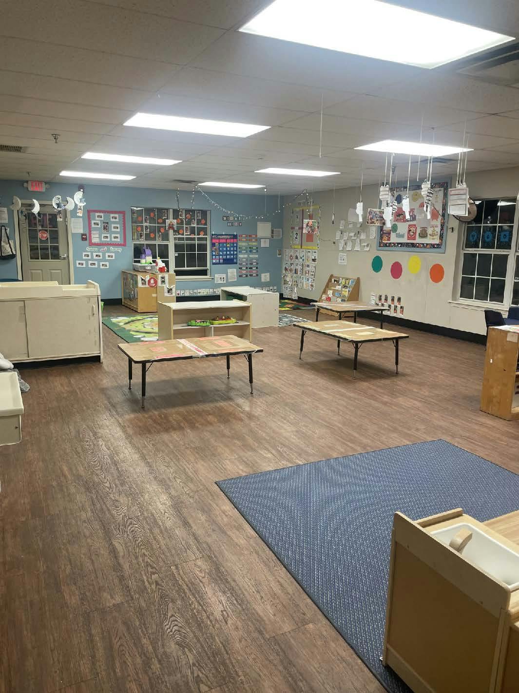 Empty classroom with small tables and decorated walls