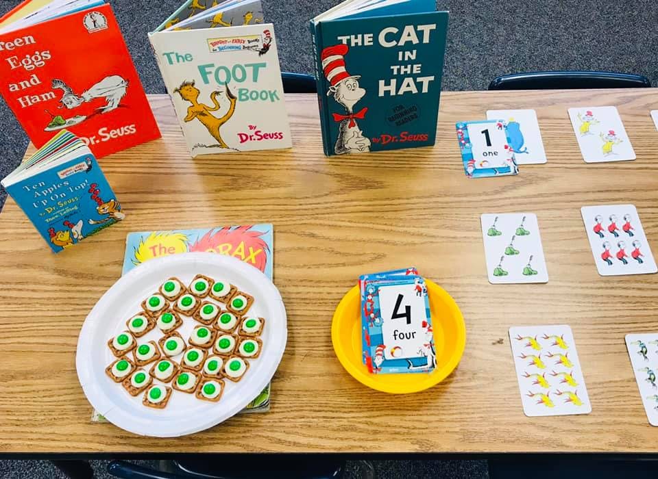 Dr. Seuss books, number cards, and cookies on a table