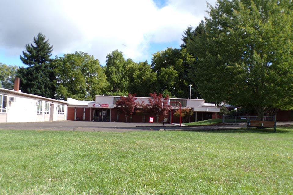 Building with a large grassy area in the foreground