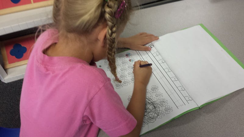 Child writing in a notebook