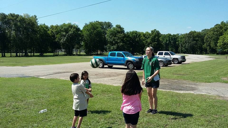 Four people playing with a ball outdoors
